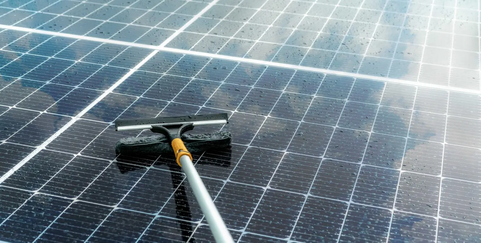 A solar panel being cleaned with an extended micro fibre cloth