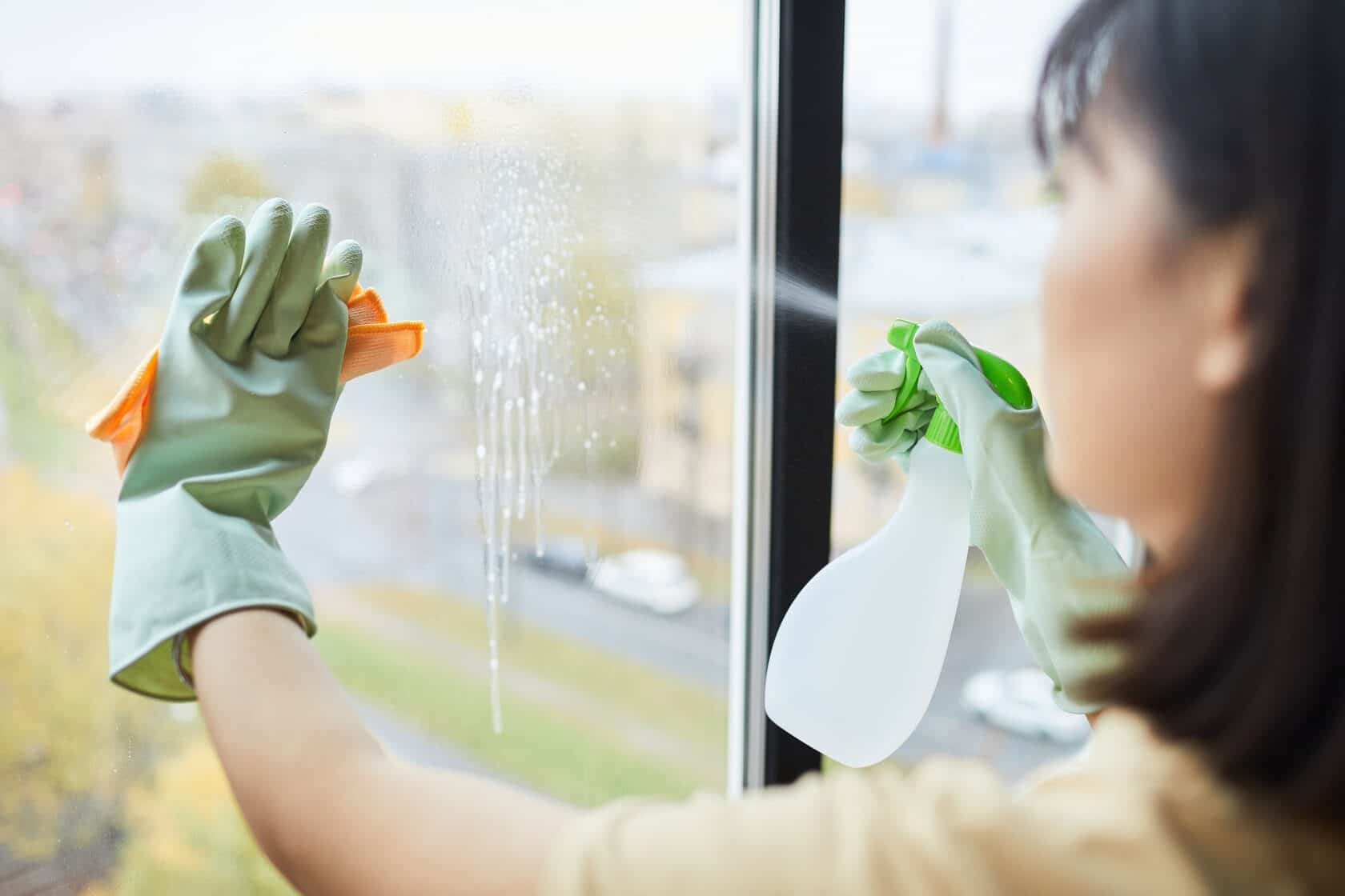 woman cleaning a window